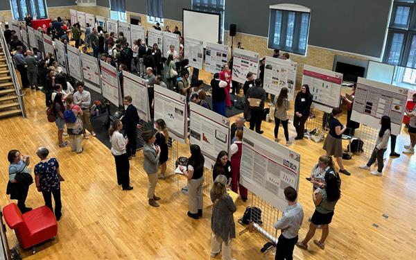 People presenting research with posters