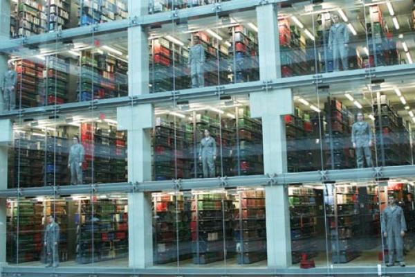 Students stand in the atrium windows of Thompson Library just before a performance starts.