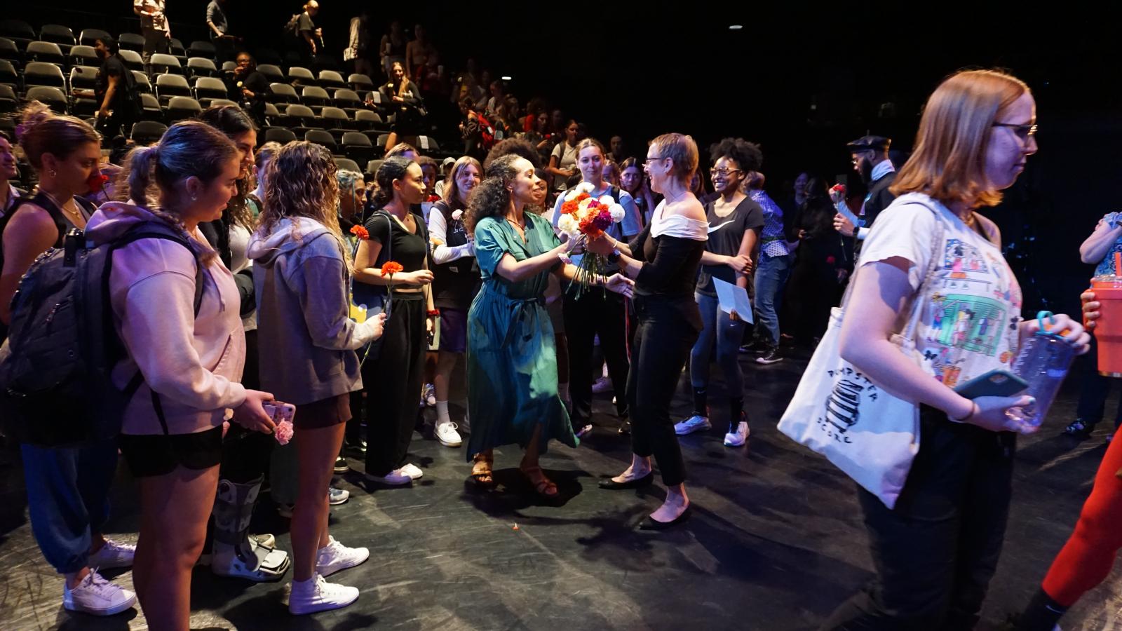 Students give flowers to Susan Van Pelt Petry