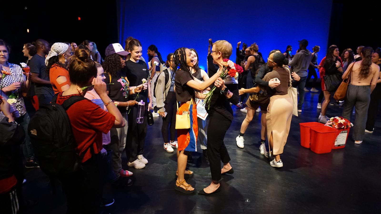 Students give flowers to Susan Van Pelt Petry