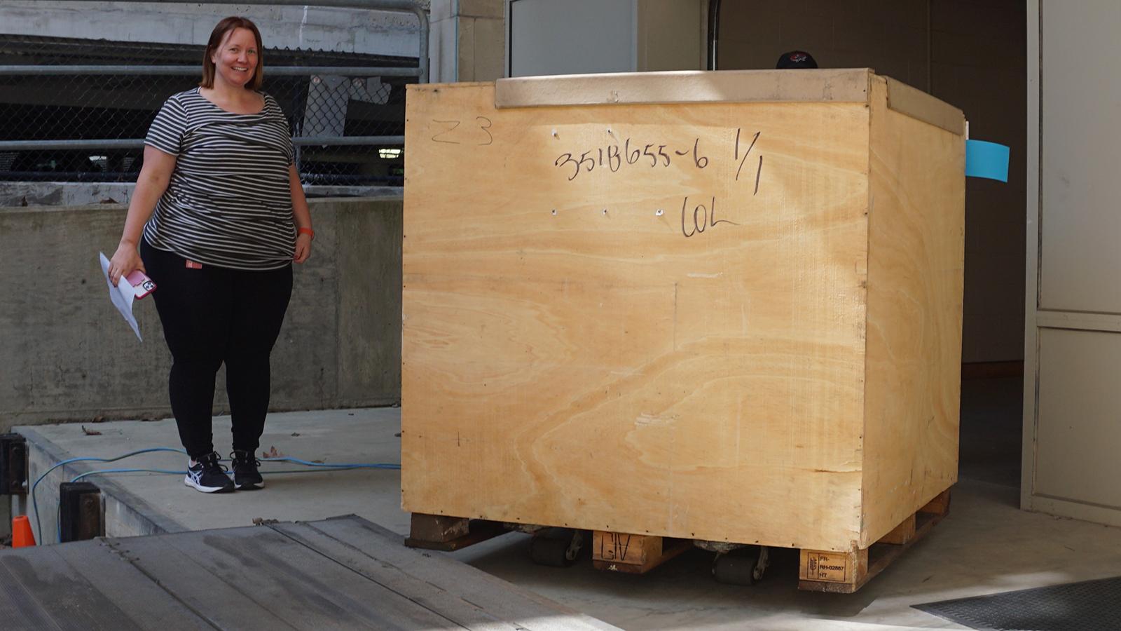 Woman standing with shipping container