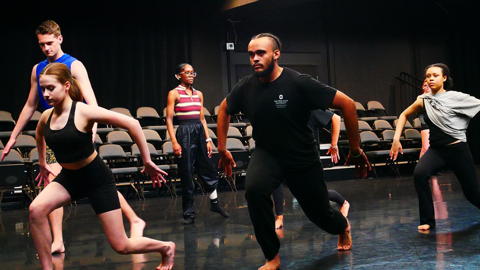 Dancers moving in a theatre