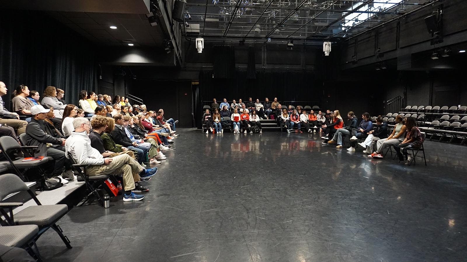 A group of people sitting in a theatre