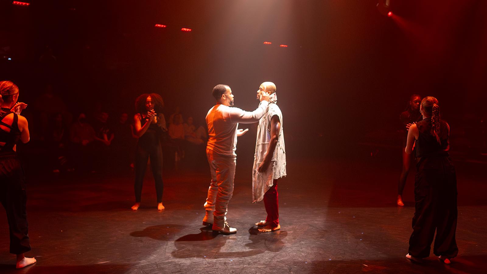 dancers dressed in white on a stage