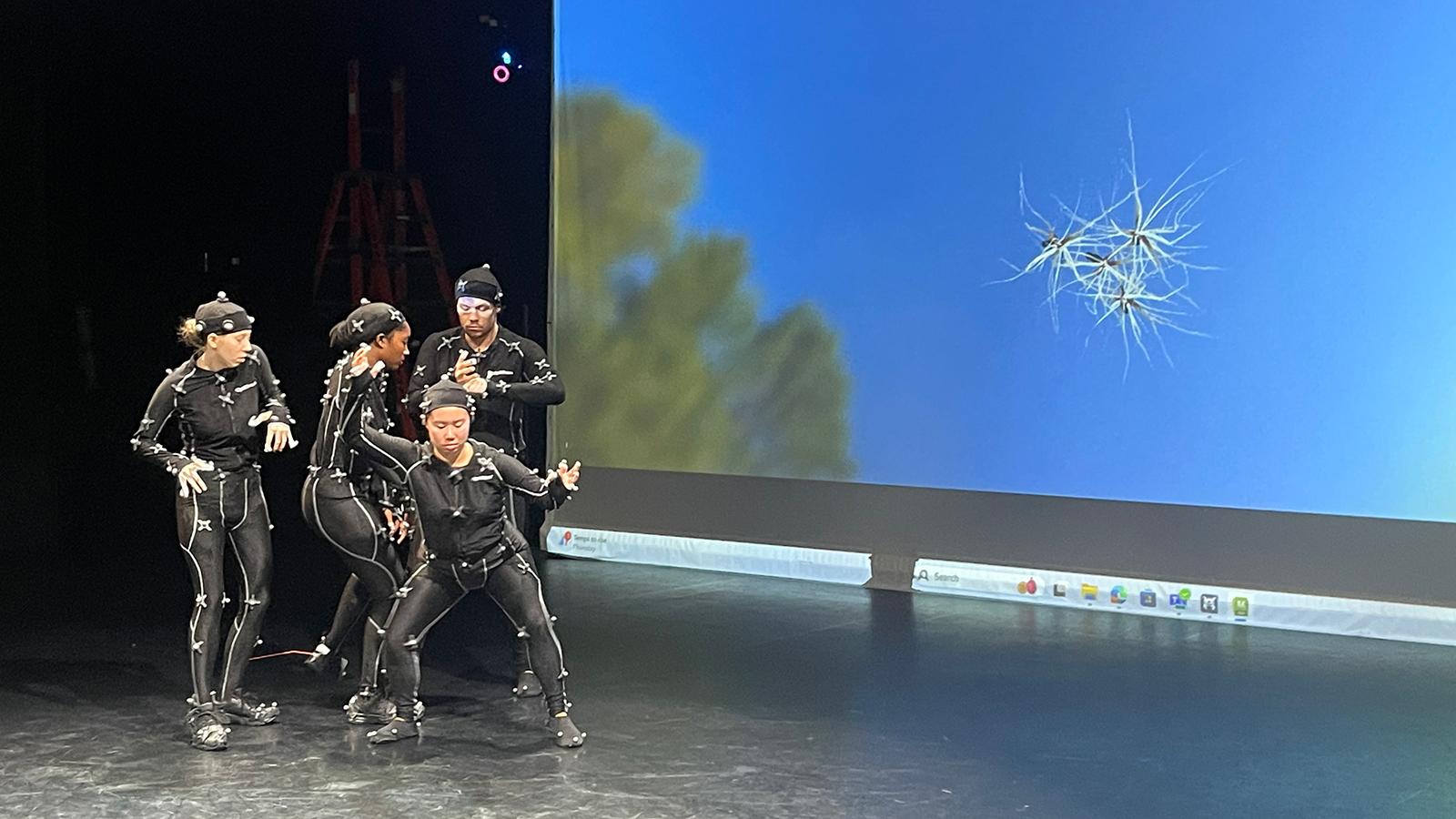 Dancers in motion capture suits rehearsing